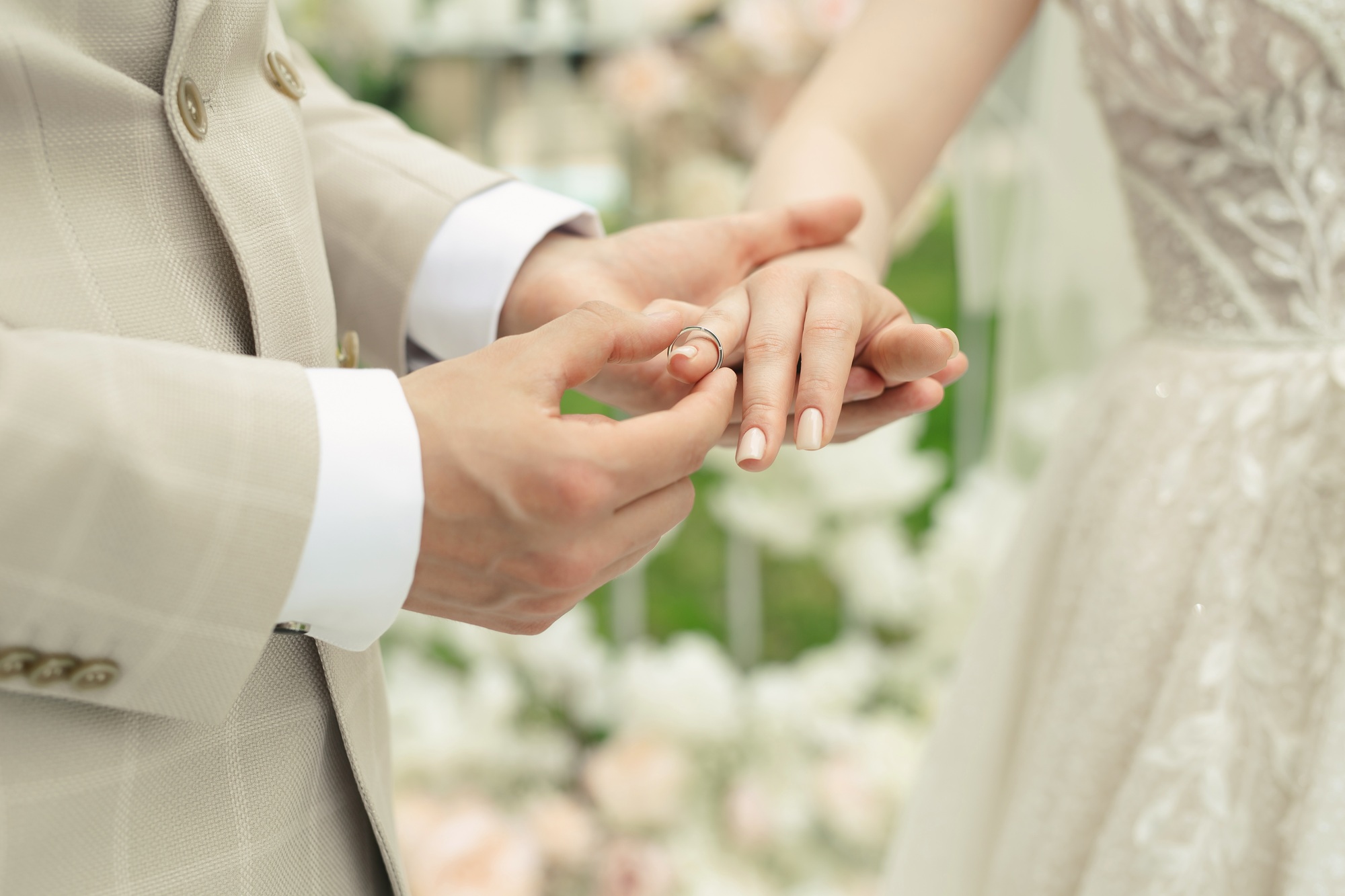 A married couple exchanges wedding rings at a wedding ceremony.
