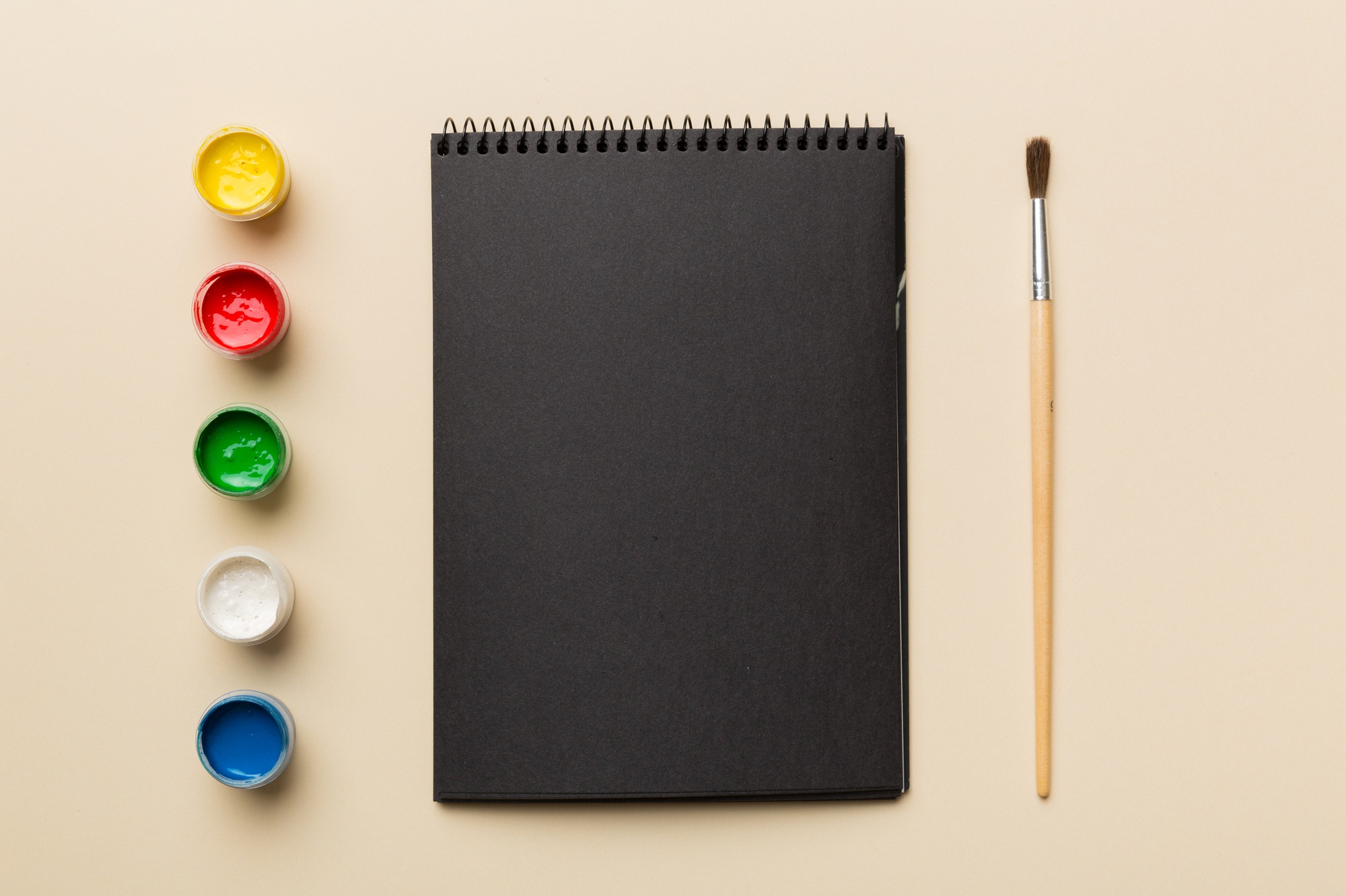 Album pages and paints, pencils, brush