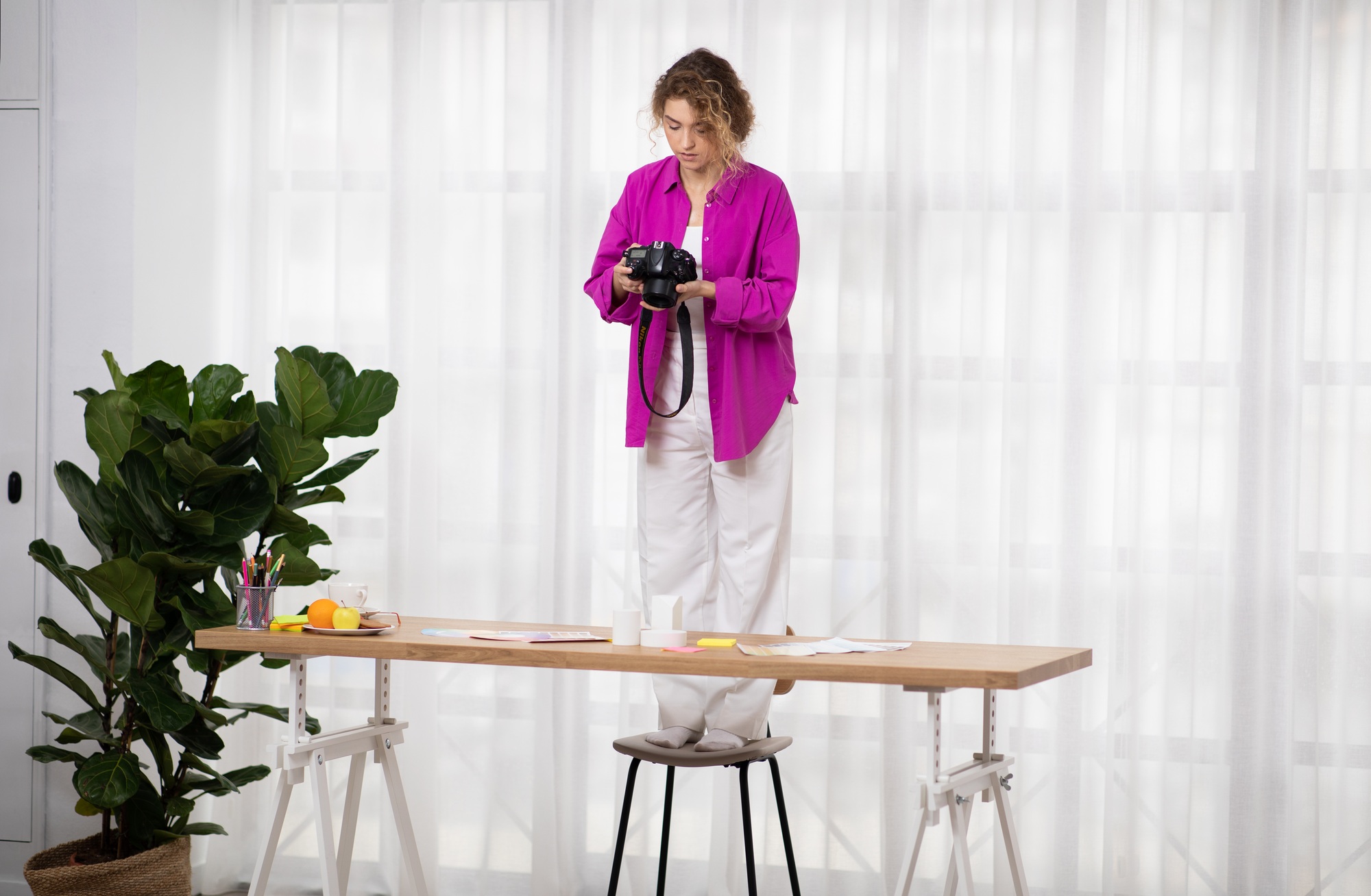 Photography. Professional Female Photographer Using Camera For Taking Photos At Home Studio