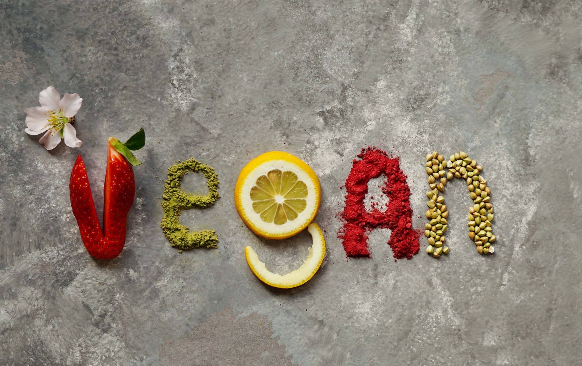 raw vegan cakes with fruit and seeds, decorated with flower, product photography for patisserie